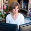 Photo of Joan Passarelli working at desk