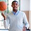 Photo of Theo Mitchell spinning a basketball