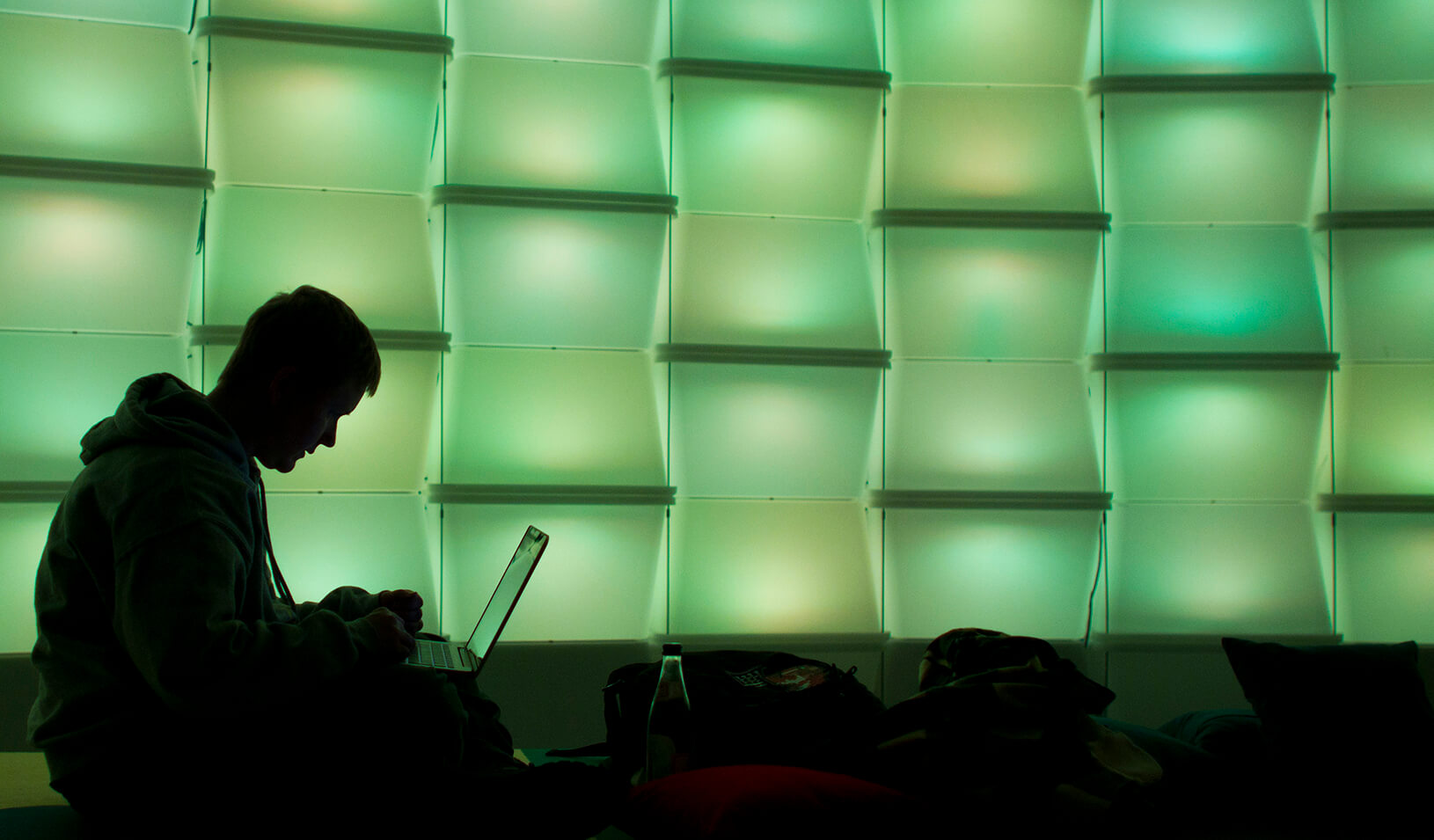 A woman uses a computer in a lounge area | Reuters/Thomas Peter