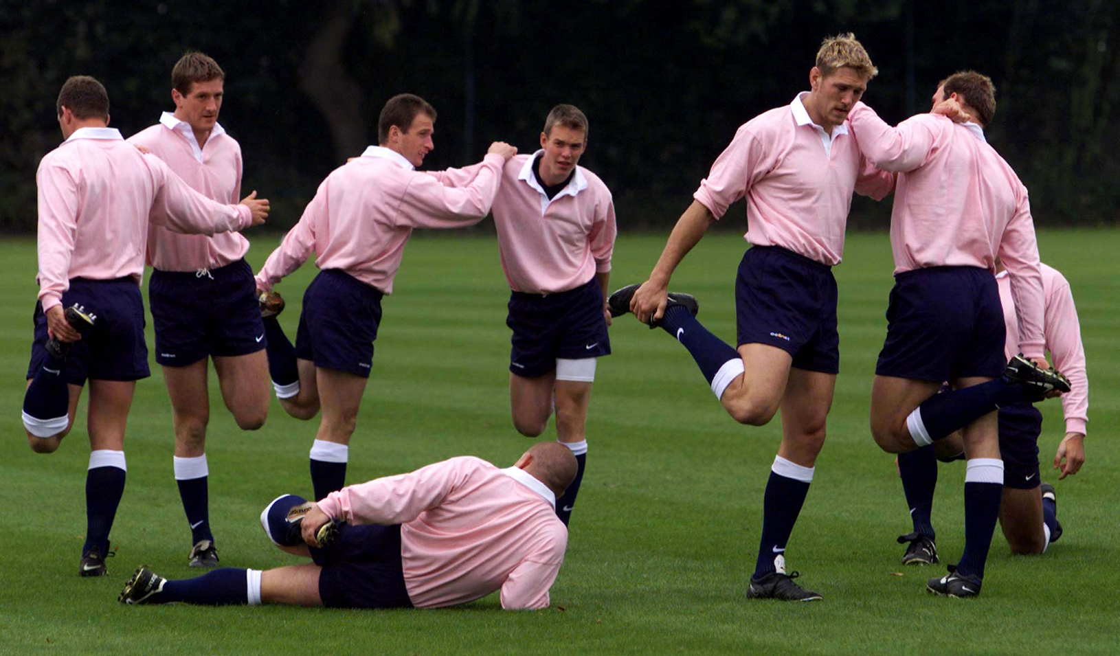 In balletic pose, wearing pink shirts to show their support for the Imperial Cancer Research Fund, the England Rugby union squad go through warm-up exercises.  Russell Boyce/Reuters