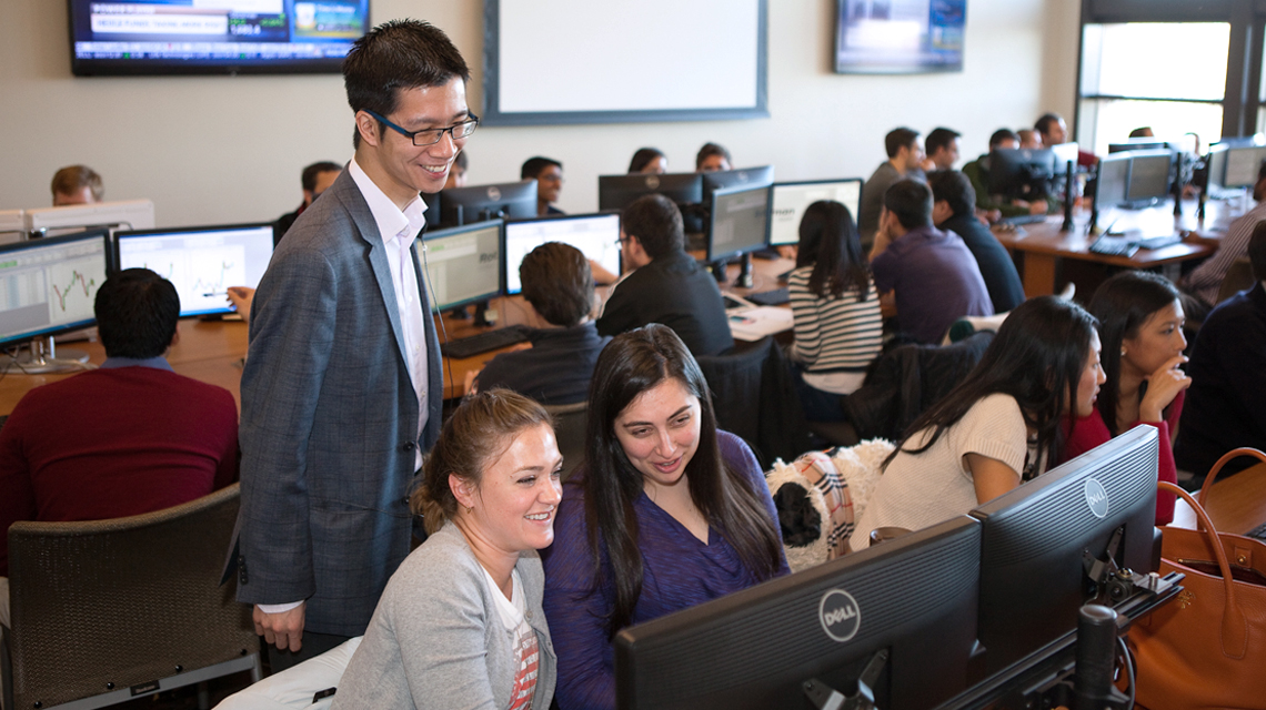 Professor Kevin Mak with students in the Real-time Investment Lab