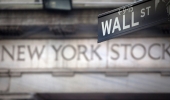 A "Wall Street" sign overlooking the New York Stock exchange | REUTERS/Carlo Allegri 