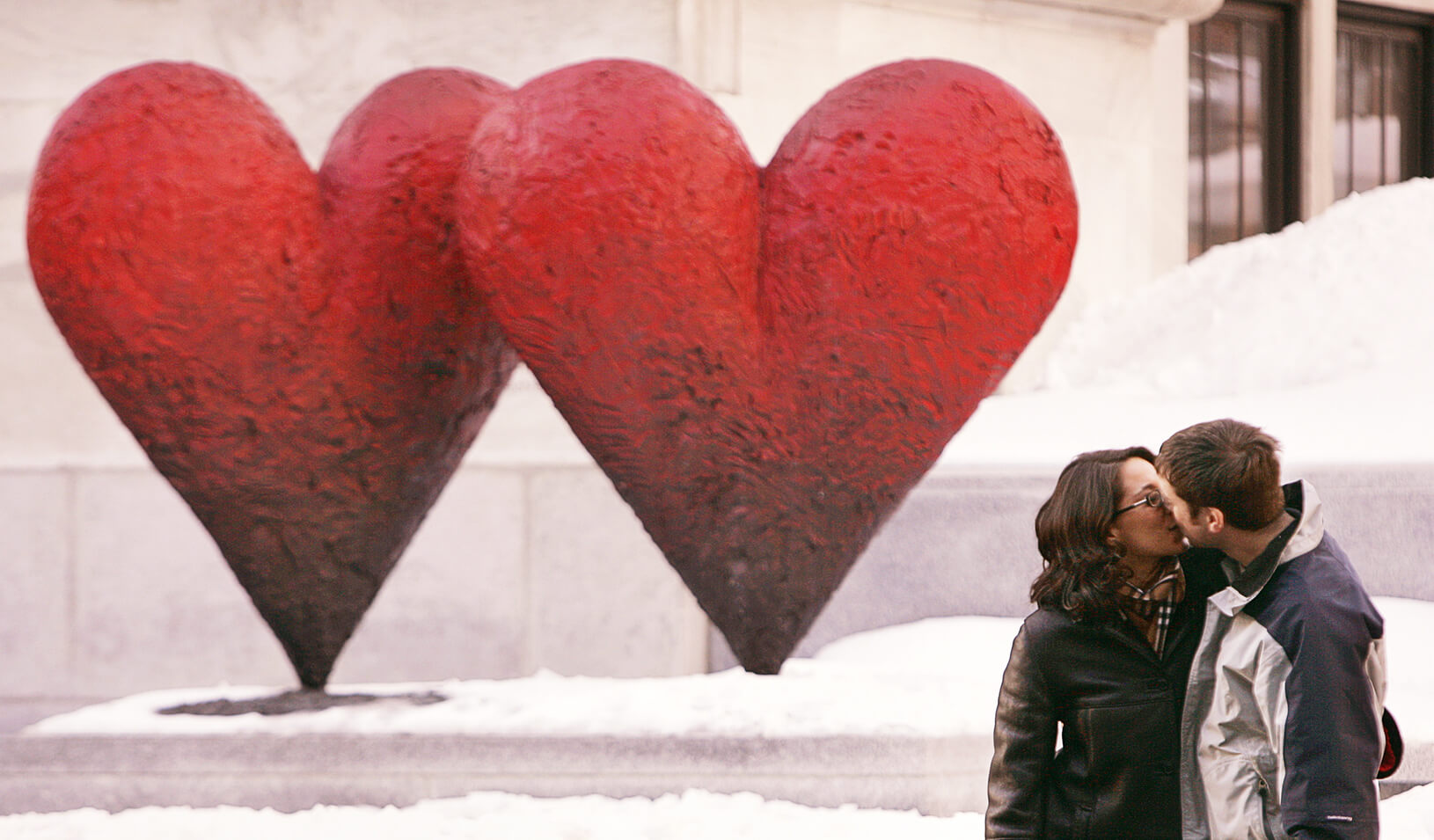 Couple kisses in front of a heart-shaped sculpture | Reuters/Shaun Best
