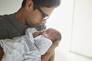 A father cradling his baby.