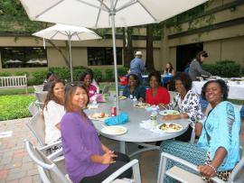 Group of attendees socializing and eating at the Stanford Staffers Potluck 2015