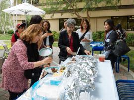 Attendees getting food at the Stanford Staffers Potluck 2015
