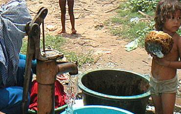 Mother and child at water pump