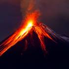 Erupting volcano at night