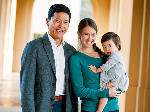 Asian male staffer and Caucasian wife with toddler daughter