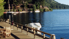 Chairs on dock along Fallen Leaf Lake, mountains and lodge in near distance