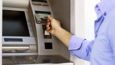 Person putting in card in ATM