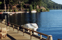 Chairs on dock along Fallen Leaf Lake, mountains and lodge in near distance