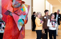 Group of visitors admiring multicolored sculpture art inside the Anderson Collection.