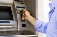 Person putting in card in ATM