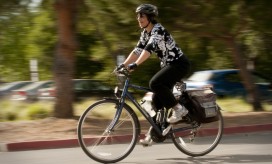 photo of woman on a bicycle