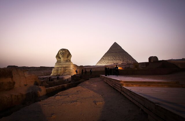 A picture taken on November 9, 2014, shows the Sphinx (L) and the pyramid of Khafre (R)  in Giza, on the outskirts of Cairo. The Egyptian Antiquities Ministry restored the courtyard in front of the Sphinx and the pyramid of King Khafre as part of their project to preserve Egypts heritage and promote tourism to the country. According to the ministry's rotation plan, one pyramid of the three pyramids of Giza will be closed every year for restoration. (Photo credit should read MOHAMED EL-SHAHED/AFP/Getty Images)