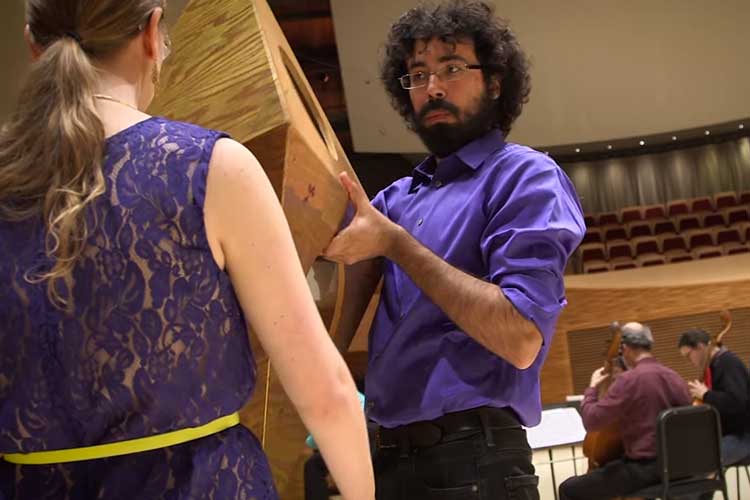Physics faculty members and graduate students use tetrahedra in a construction performance, accompanied by four members of the Philharmonia Baroque Orchestra.