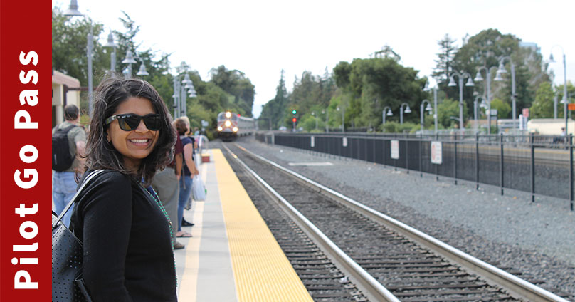 Smiling woman standing on Caltrain platform