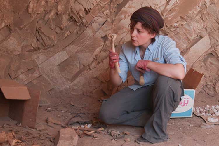 Anne Austin holding an ancient bone.