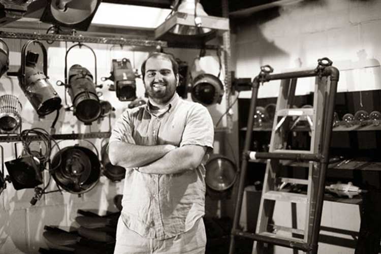 Matt Lathrop portrait in front of theater lighting fixtures