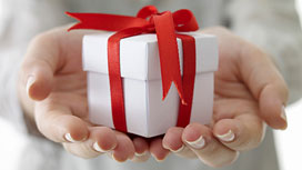 Photo of the hands holding a gift box