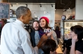 President Obama Looks At A Selfie With Restaurant Staff