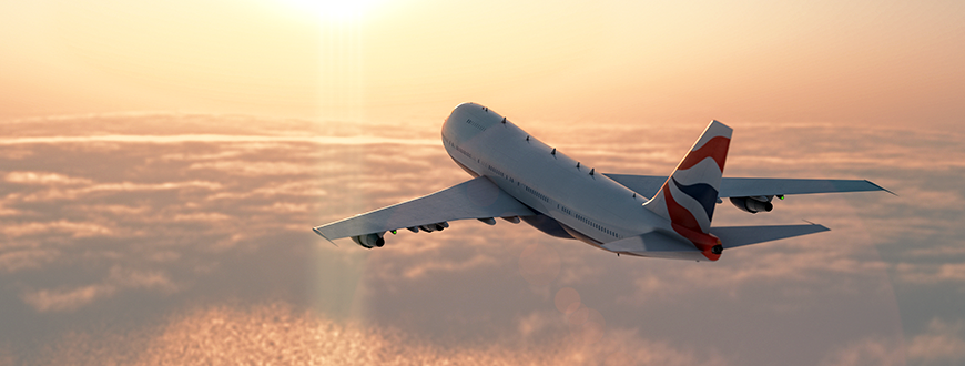 Commercial airplane flying among clouds at dusk