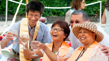 Staff honorees at service recognition ceremony toasting glasses