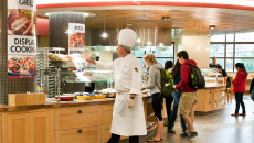 Arillaga Family Dining Commons cafeteria: chef, students and staff near the grill section.