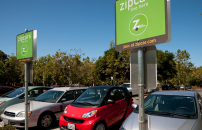 Designated Zipcar parking section with green signs on campus.