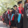 students lining up in commencement attire