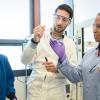 three students interacting in a lab