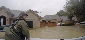 rescuer in boat in Houston flooding