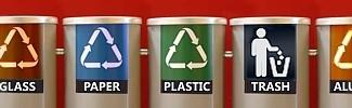Image of glass, papaer, plastic, trash , aluminum trash receptacles in a line.