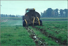 tractor in a farm field laying water lines