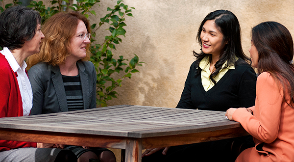 Supportive group of colleagues talking around a table