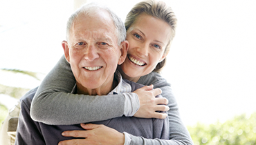 Woman embracing elderly father