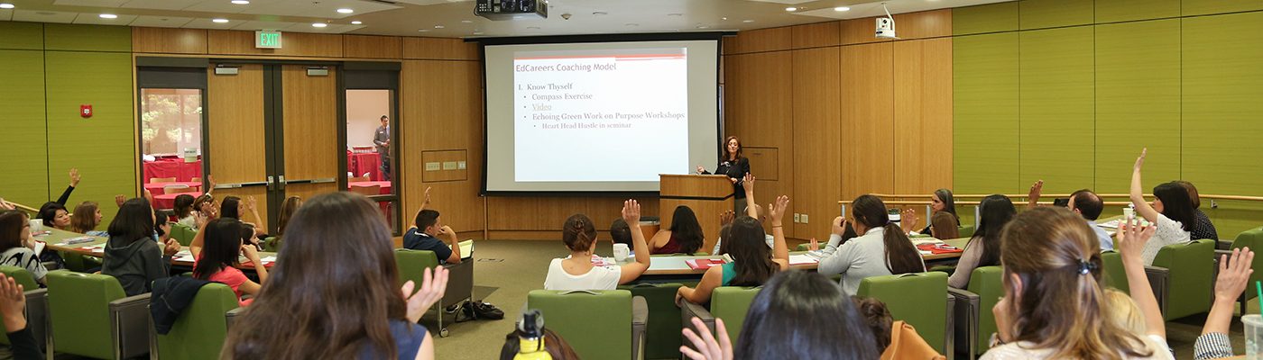 Person giving a presentation in front of an audience.