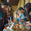 Students making candied houses for the holidays.