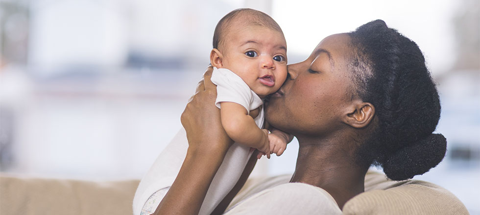 Mother kissing baby's cheek