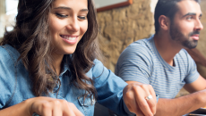 Female and male enjoying meal in cafeteria