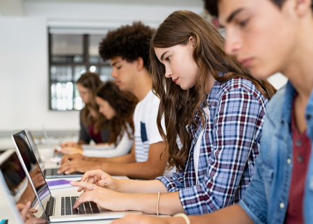 Students typing on laptops