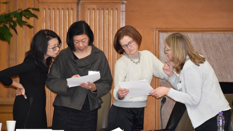 Participants look over conference proceedings