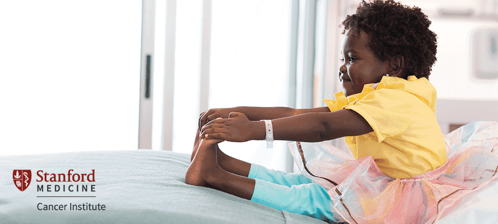 Young patient reaching for her toes in a ballerina tutu