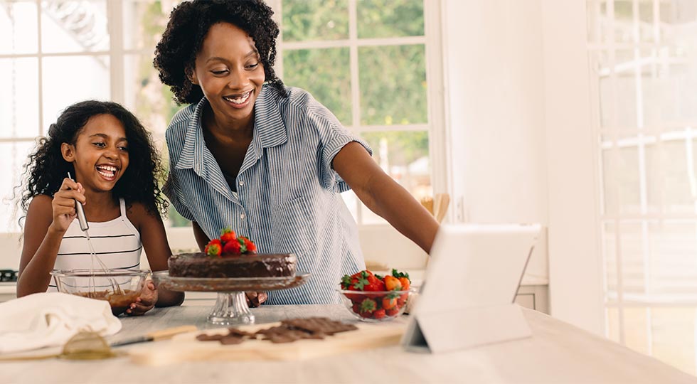 Mother and daughter baking a cake together