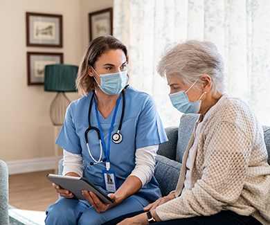 A masked patient consults a physician